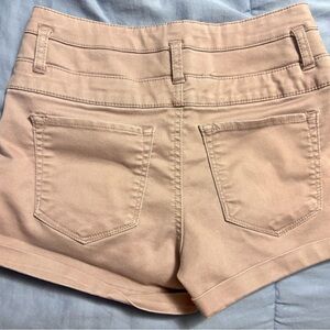 Rose gold high waisted shorts with bronze colored buttons